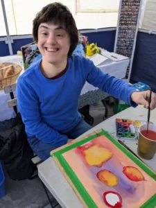 Rita painting in the sukkah in KIngston.